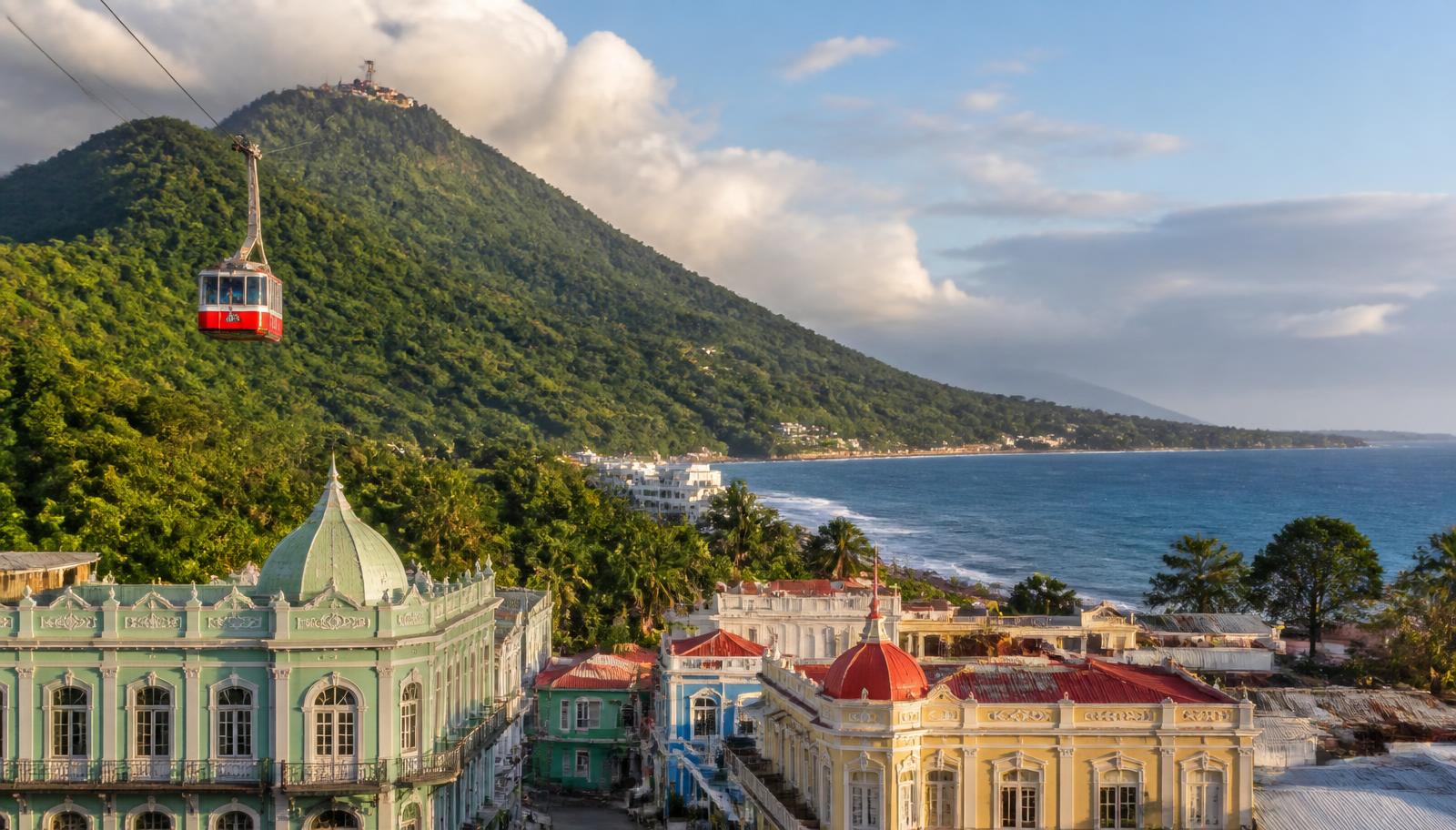 Puerto Plata coastline with green mountains, the Atlantic surf, and the Mount Isabel de Torres cable car above the city