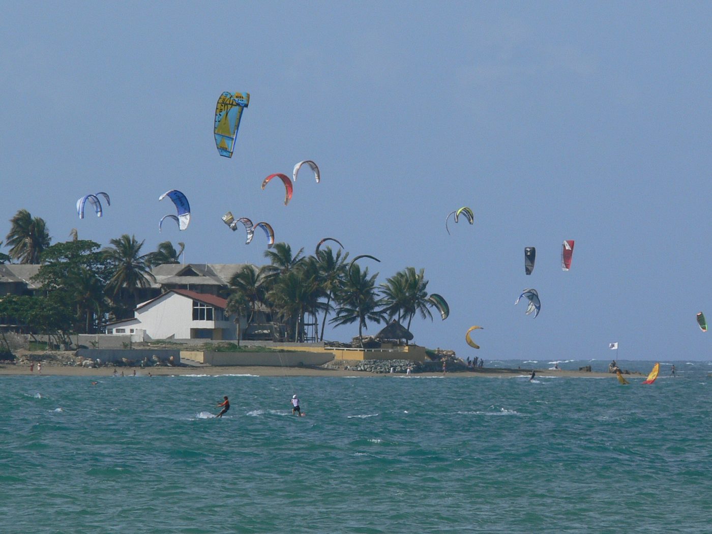 Kitesurfers riding in strong afternoon wind off Cabarete beach on the Dominican north coast