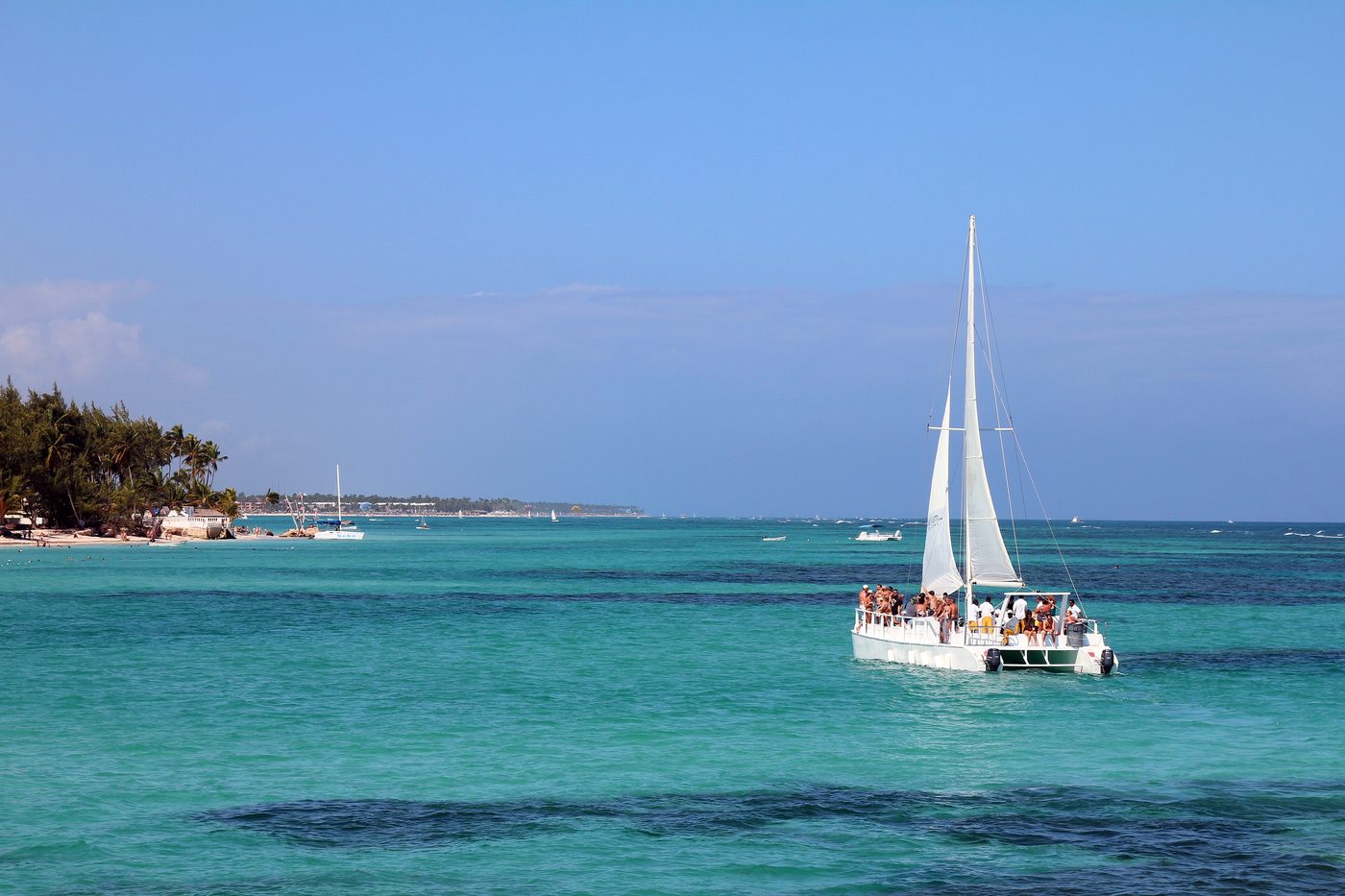 Friends on a catamaran boat day off the coast of tropical Caribbean