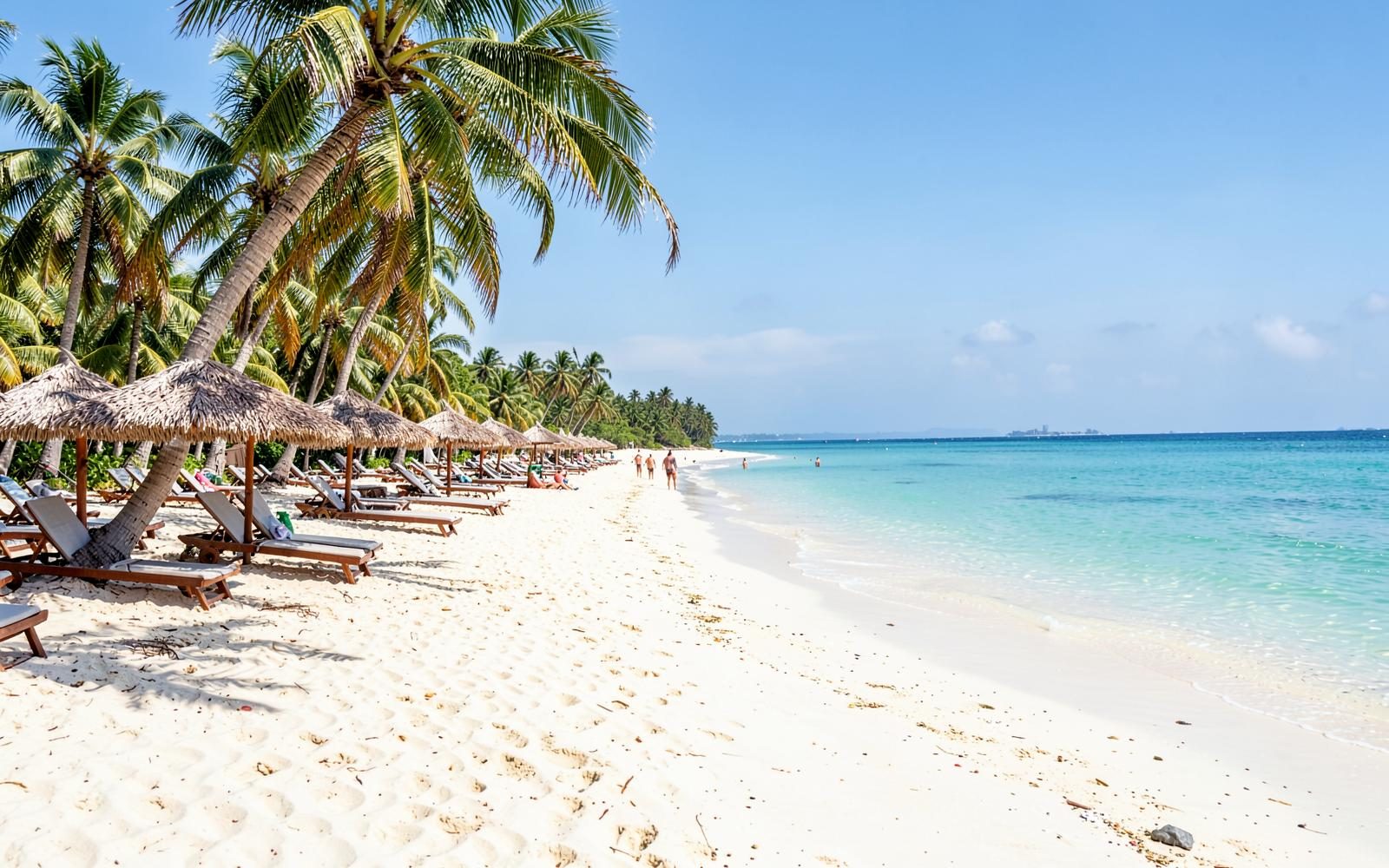 Palm-lined Bavaro beach in Punta Cana with turquoise Caribbean water and resort loungers