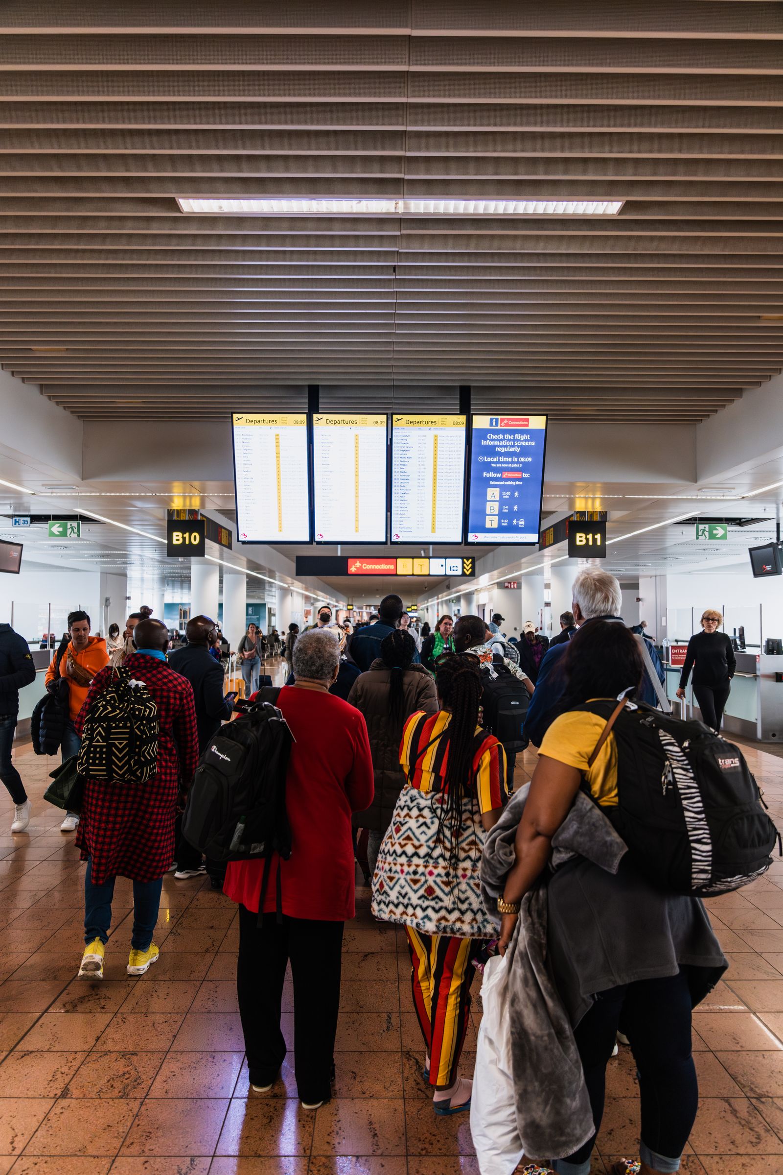 Travelers moving through an airport terminal