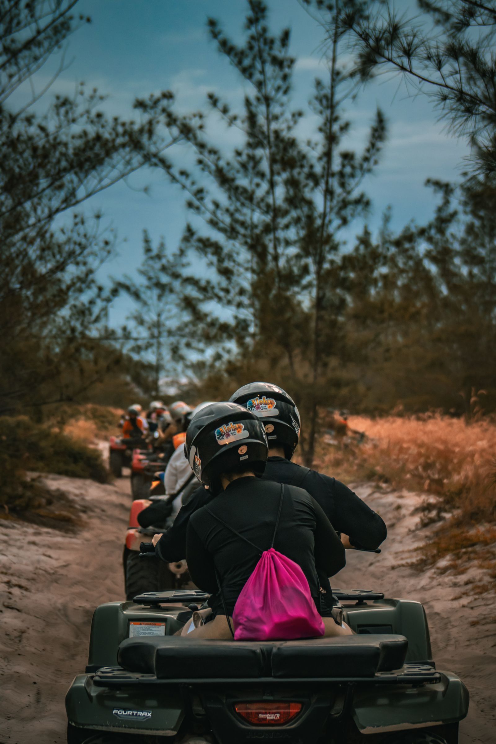 A group riding ATVs on a sandy trail in the Dominican Republic