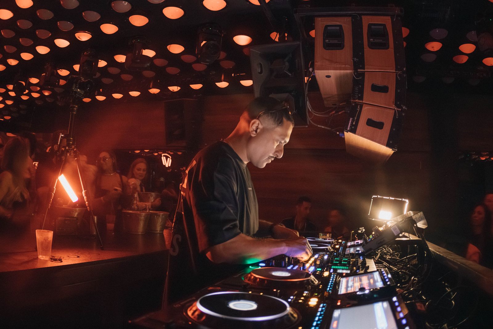 A DJ performing in a packed club