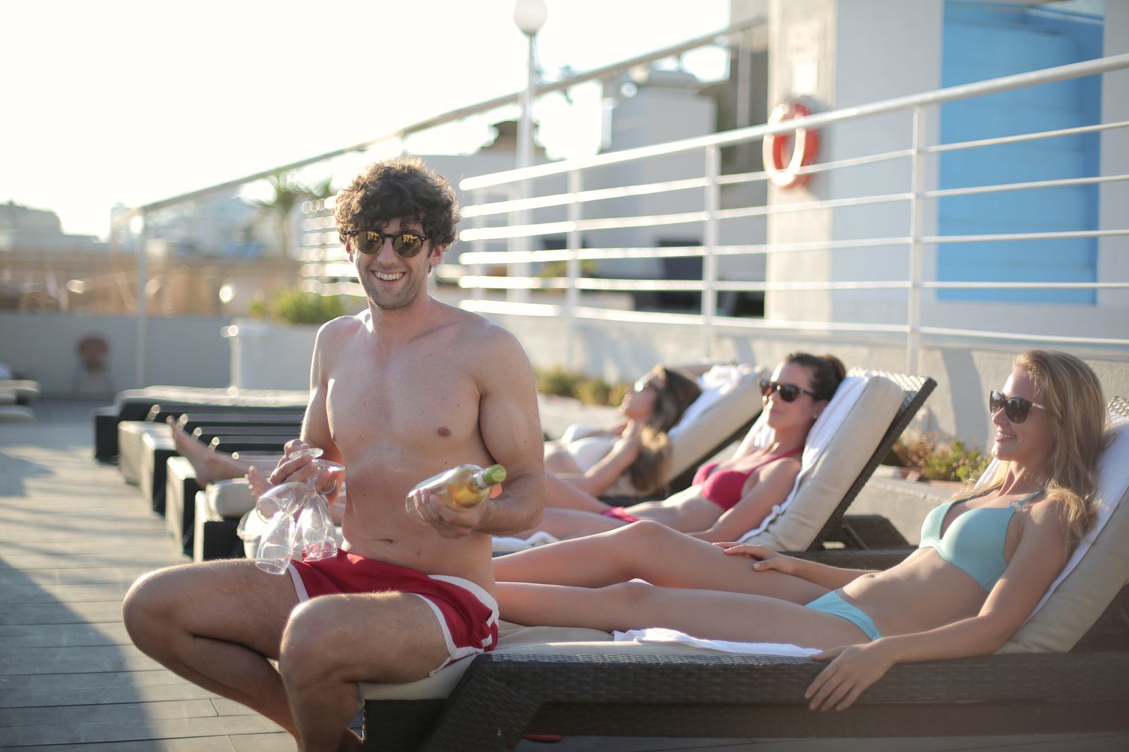 Adults relaxing at an upscale resort pool deck with drinks